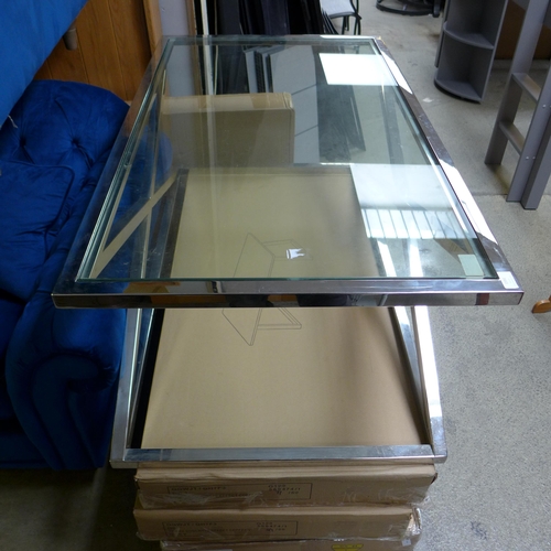 1591 - A chrome coffee table with glass top and x-frame base