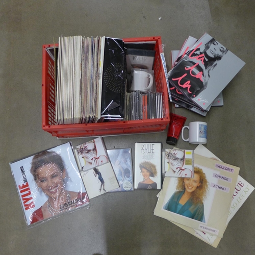 1233 - A collection of Kylie Minogue memorabilia including LP records (some duplicates), CDs, mugs, 45rpm v... 