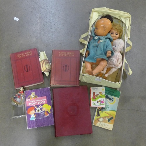 1237 - Four plastic dolls in a cot including Kader and children's books including two volumes of Nature Sto... 