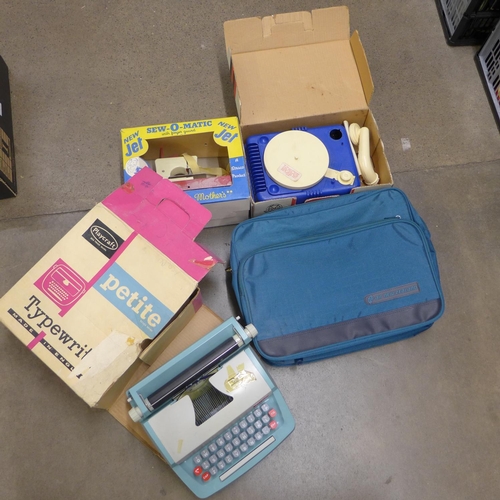 1253 - A Playcraft typewriter, Lumar toy gramophone and a Sew-O-Matic sewing machine, all boxed **PLEASE NO... 