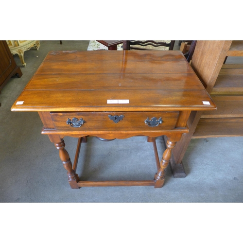 240 - An 18th Century style hardwood single drawer side table