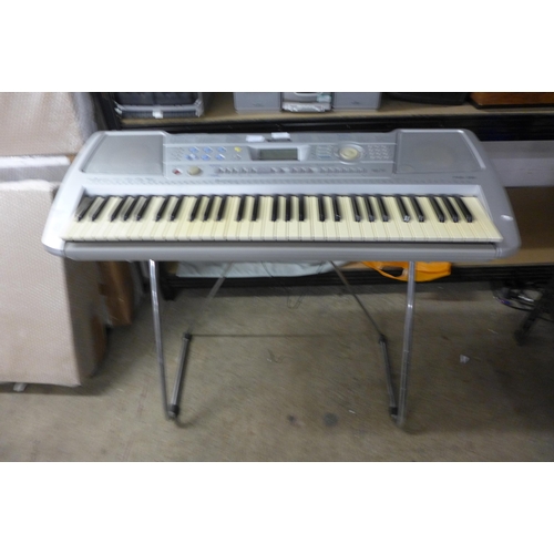 2212 - Yamaha keyboard with stand, instructions & sheet music