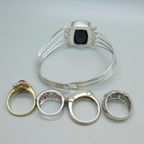 1134 - Four silver rings and a bangle