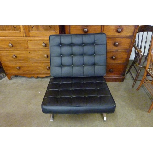 11 - A Barcelona style chrome and black leather lounge chair and stool