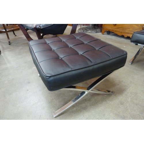 11 - A Barcelona style chrome and black leather lounge chair and stool