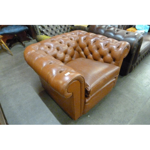 124 - A brown leather Chesterfield club chair