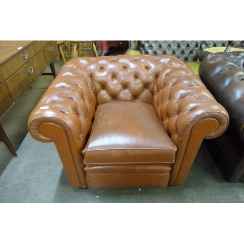 124 - A brown leather Chesterfield club chair