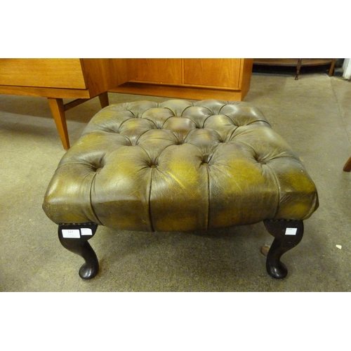 127 - A green leather footstool