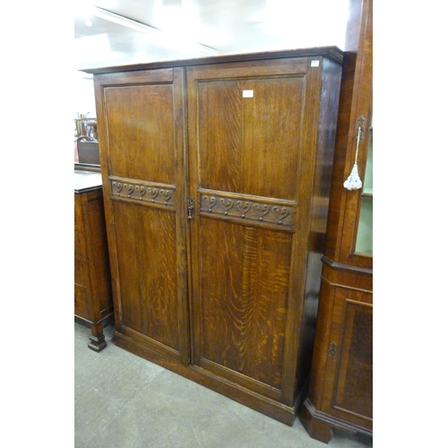 133 - An early 20th Century fitted oak two door gentleman's wardrobe