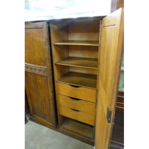 133 - An early 20th Century fitted oak two door gentleman's wardrobe