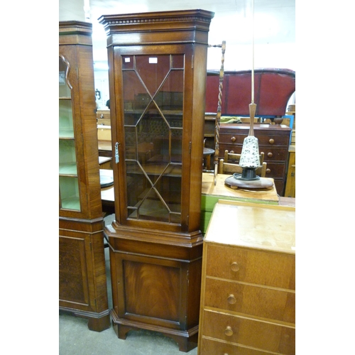 135 - A mahogany freestanding corner cabinet