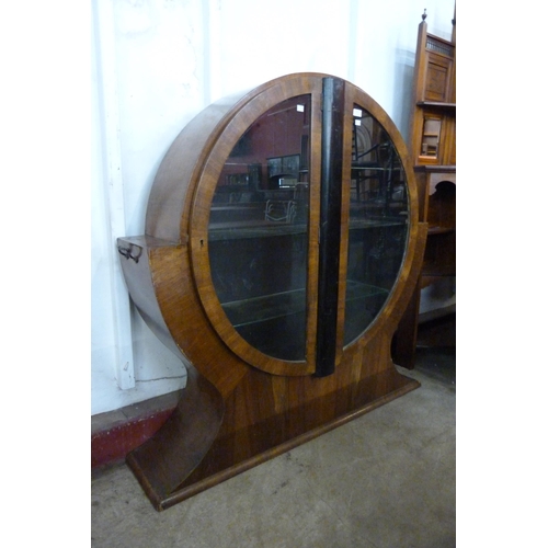 141 - An Art Deco walnut two door circular display cabinet