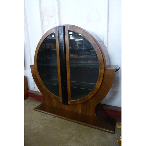 141 - An Art Deco walnut two door circular display cabinet