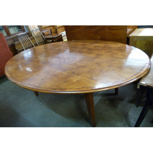 145 - A large George III style oval elm farmhouse dining table