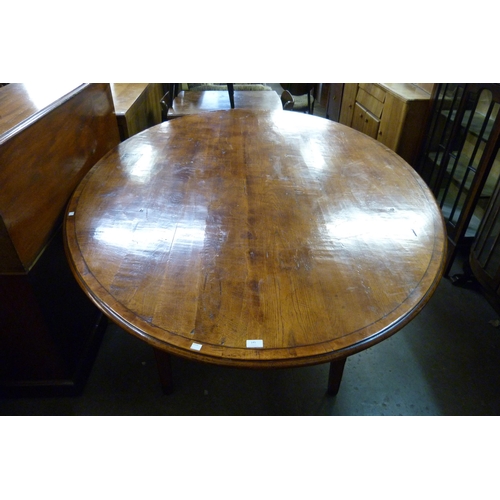 145 - A large George III style oval elm farmhouse dining table