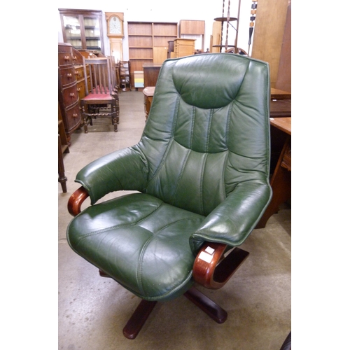 155 - A beech and green leather revolving lounge chair