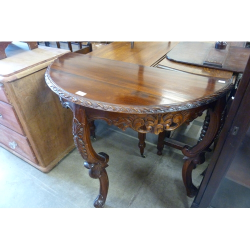 192 - A French style carved hardwood demi-lune console table