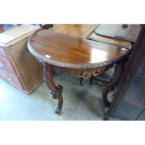 192 - A French style carved hardwood demi-lune console table