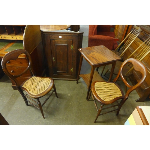 212 - A George III oak splay front wall hanging corner cupboard, a mahogany occasional table and two chair... 