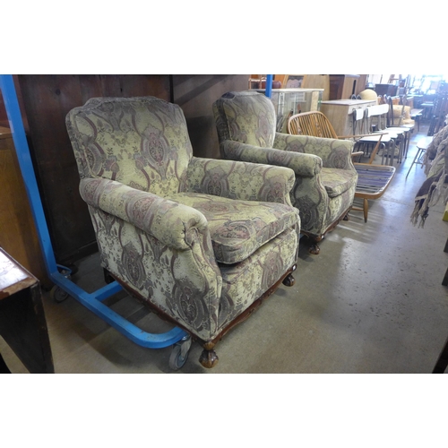 215 - A pair of early 20th Century Chippendale Revival carved mahogany and fabric upholstered armchairs