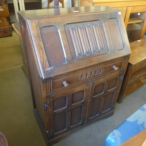 237 - A carved oak linenfold bureau