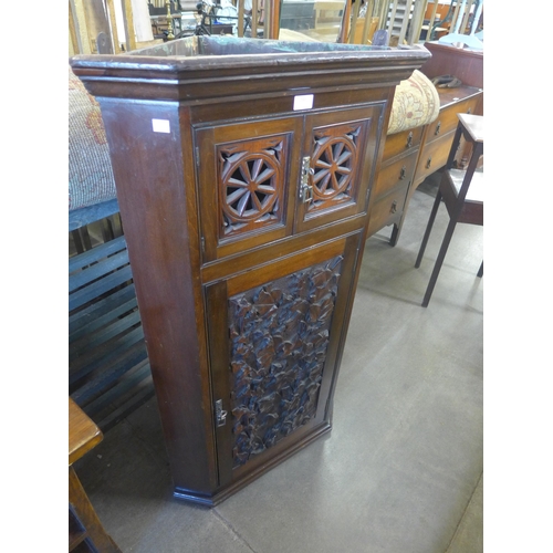 243 - A Victorian Aesthetic Movement carved walnut splay front wall hanging corner cupboard