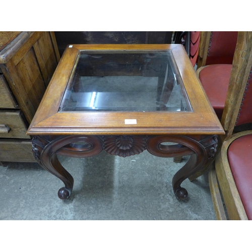 272 - A French style carved hardwood and glass topped coffee table