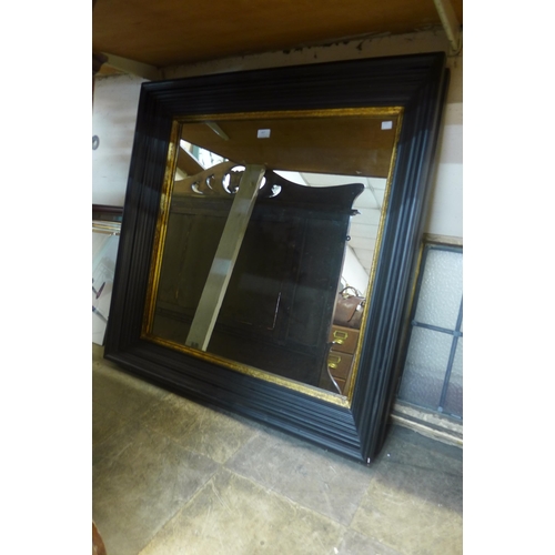 457 - A square ebonised and parcel gilt framed mirror