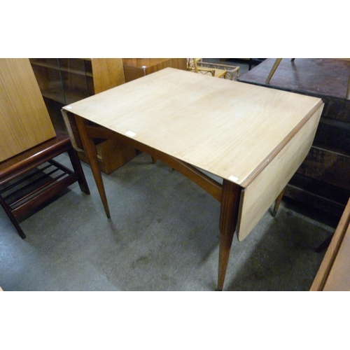 61 - A Danish teak drop leaf dining table and six chairs