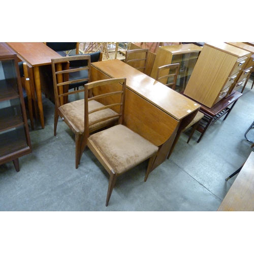 67 - A teak drop-leaf dining table and four chairs