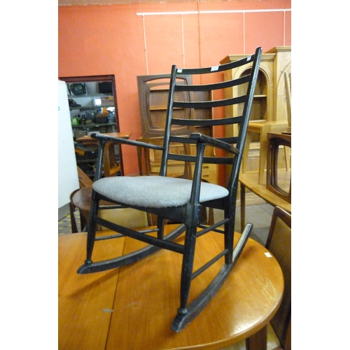 77 - A Danish ebonised beech rocking chair