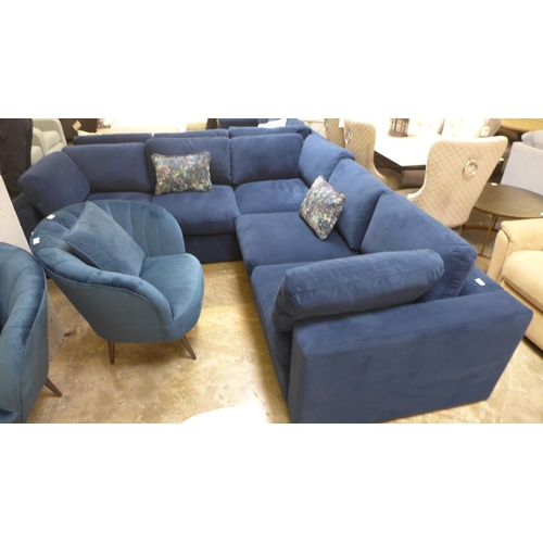 1476 - A large blue velvet six seater corner sofa