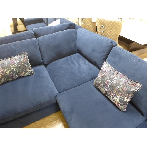 1476 - A large blue velvet six seater corner sofa