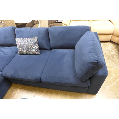 1476 - A large blue velvet six seater corner sofa