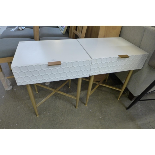 1542 - A pair of white bedside tables with cross legs