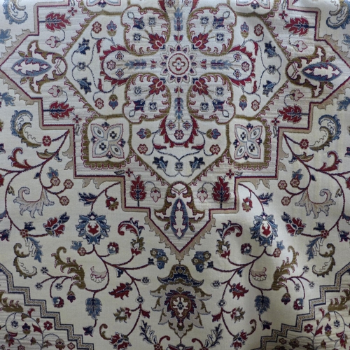 1444 - A cream and red ground full pile Cashmere carpet with central medallion design, 300cm x 200cm