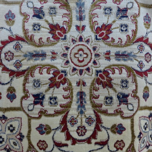 1444 - A cream and red ground full pile Cashmere carpet with central medallion design, 300cm x 200cm