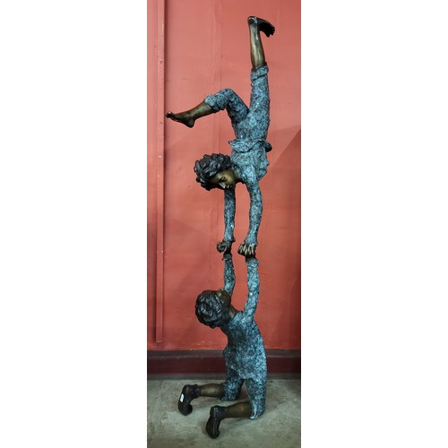 108 - A large bronze figure group of balancing boys