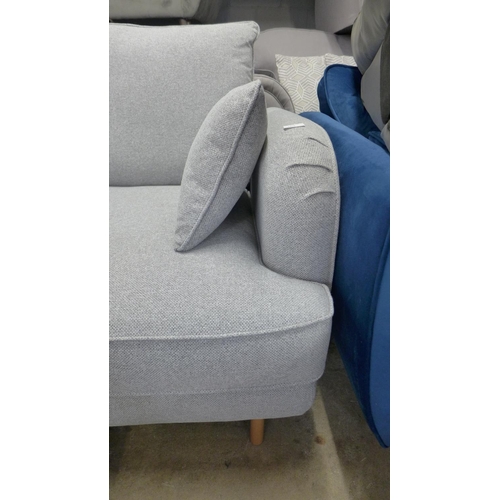 1427 - A grey textured weave upholstered six seater corner sofa, slight damage to arm