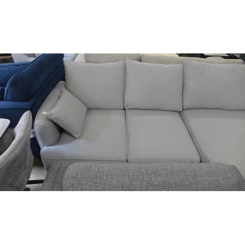 1427 - A grey textured weave upholstered six seater corner sofa, slight damage to arm