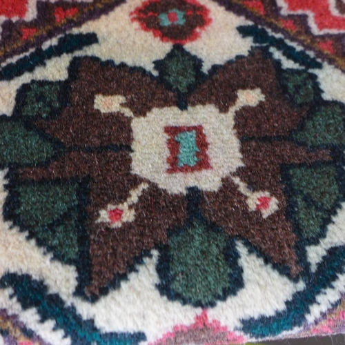 1496 - A fine hand woven Persian village runner with bespoke all over design, 290cm x 92cm