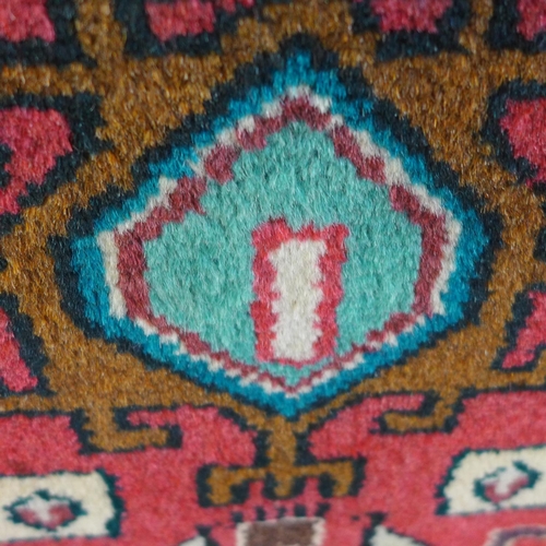 1496 - A fine hand woven Persian village runner with bespoke all over design, 290cm x 92cm