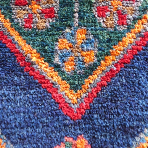 1532 - A rich red and blue ground Persian Hamadan village rug, 254cm x 132cm
