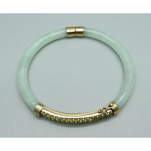 1004 - A 9ct gold and jade bangle set with green stones