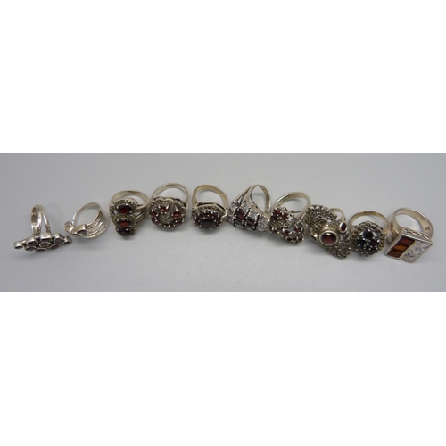 1032 - Ten large 'chunky' silver and garnet set rings, 101.62g