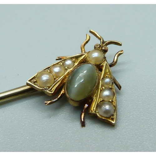 1050 - A chrysoprase and pearl set insect stick pin, (acid tests as high carat gold with 9ct gold pin)