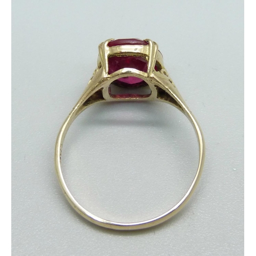 1062 - A 9ct gold and ruby solitaire ring, 1.9g, M