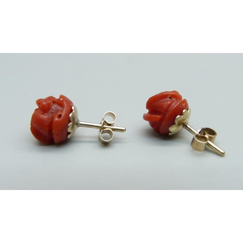 1067 - A pair of coral ear studs, the fasteners marked 9ct