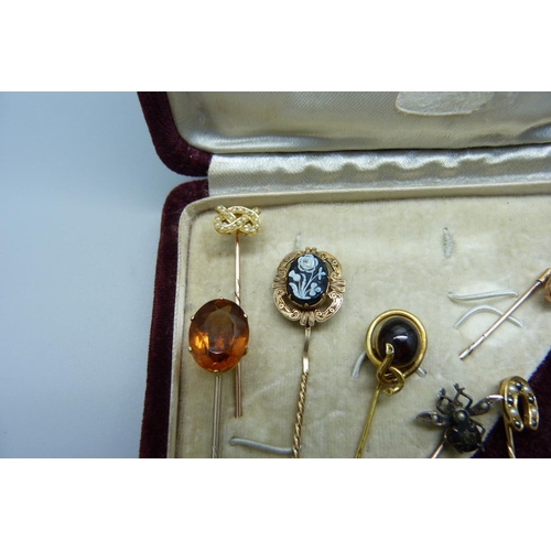 1082 - A collection of eleven pins; one 15ct gold and set with a small diamond, one 9ct gold and set with t... 