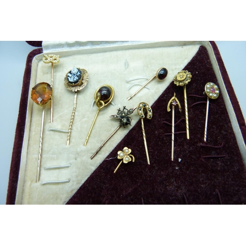 1082 - A collection of eleven pins; one 15ct gold and set with a small diamond, one 9ct gold and set with t... 